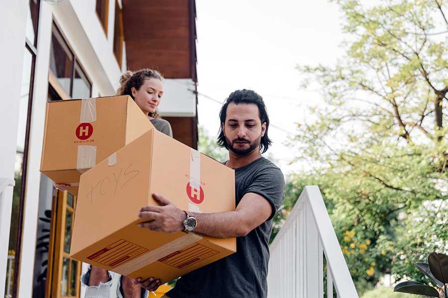 couple carrying boxes