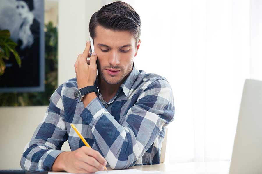 man on phone with debt collector
